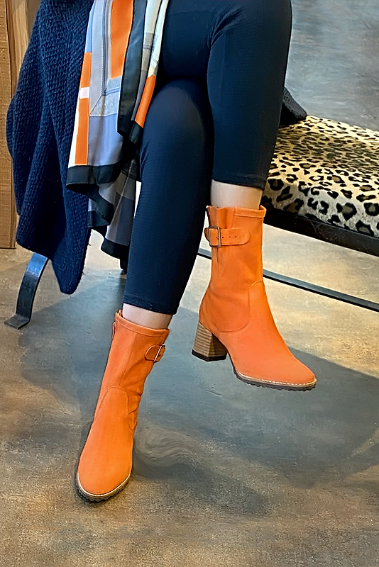 Apricot orange women's ankle boots with buckles on the sides. Round toe. Medium block heels. Worn view - Florence KOOIJMAN